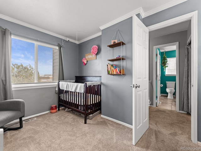 carpeted bedroom with ornamental molding, a nursery area, visible vents, and baseboards