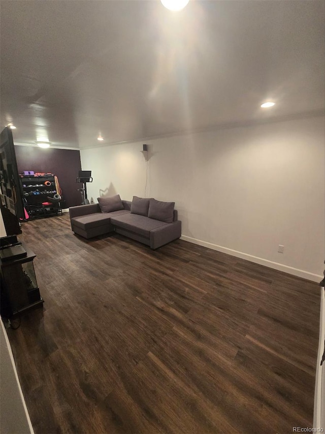 living area with dark wood-style floors, baseboards, and recessed lighting