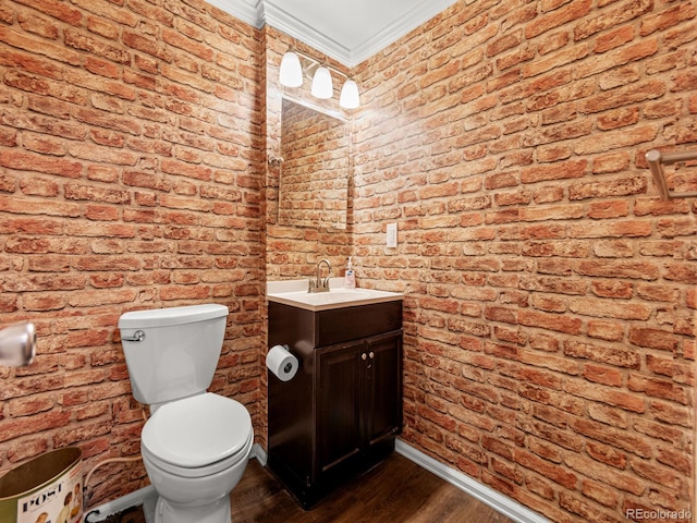 half bath with brick wall and wood finished floors