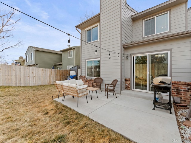 rear view of property featuring fence, an outdoor living space, a lawn, a chimney, and a patio area