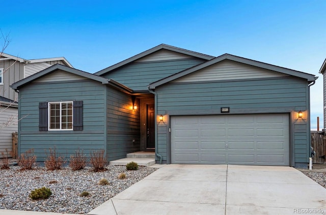 ranch-style home featuring concrete driveway and a garage