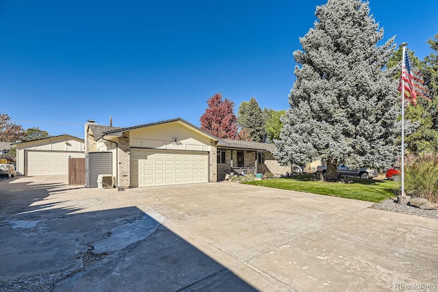 ranch-style home featuring a garage and a front lawn