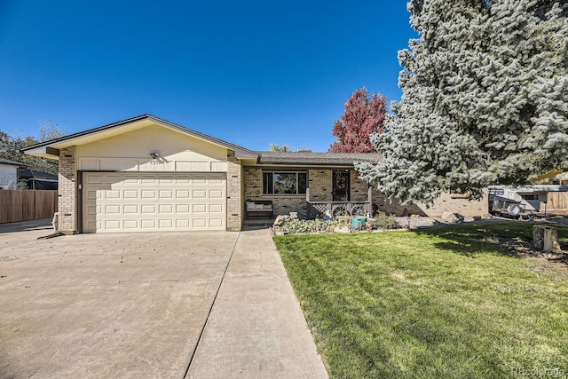 ranch-style home with a front yard and a garage