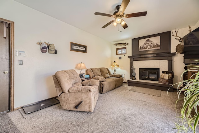 living room with carpet flooring, a tile fireplace, and ceiling fan