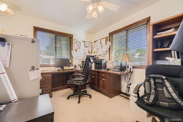 office space with ceiling fan and light carpet