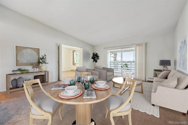 725 S Alton Way Unit 7D, Denver, CO 80247 - dining area featuring baseboard heating, lofted ceiling, and light carpet