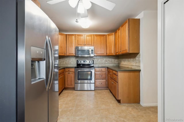725 S Alton Way Unit 7D, Denver, CO 80247 - kitchen featuring stainless steel appliances, tasteful backsplash, dark countertops, light tile patterned flooring, and brown cabinetry