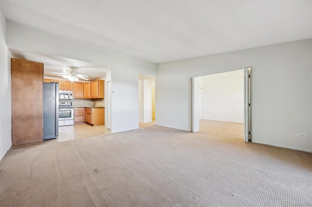 725 S Alton Way Unit 7D, Denver, CO 80247 - unfurnished living room with light colored carpet and a ceiling fan