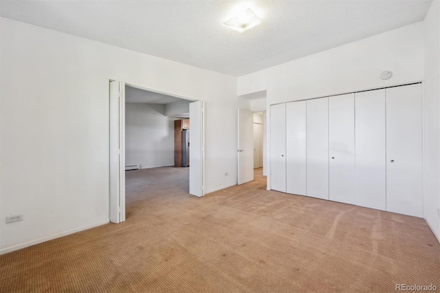 725 S Alton Way Unit 7D, Denver, CO 80247 - unfurnished bedroom with light colored carpet, a closet, and a baseboard radiator