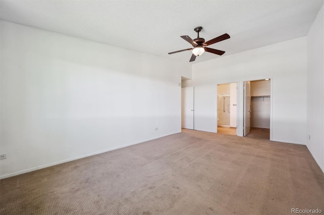725 S Alton Way Unit 7D, Denver, CO 80247 - unfurnished bedroom featuring light carpet, a spacious closet, a closet, and a ceiling fan