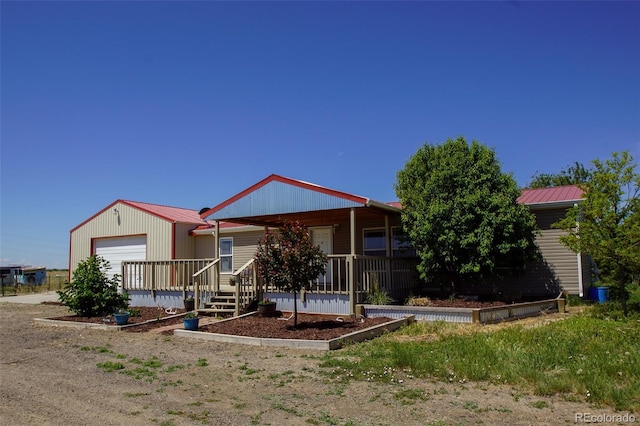 view of front of house featuring a porch and a garage