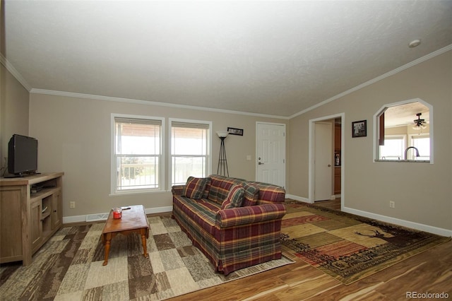 living room featuring ceiling fan, crown molding, and a textured ceiling