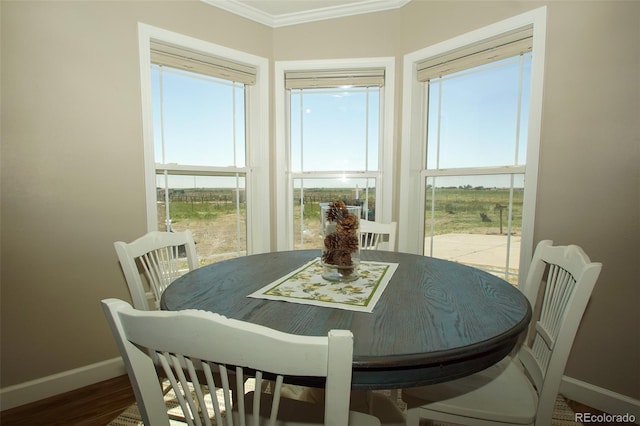 dining room featuring hardwood / wood-style floors and ornamental molding