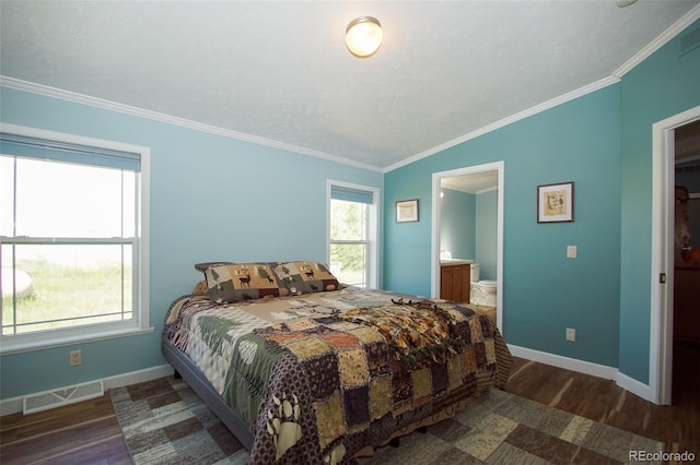 bedroom with multiple windows, ensuite bathroom, dark hardwood / wood-style flooring, and ornamental molding