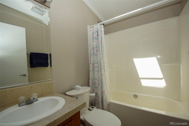 full bathroom with a skylight, vanity, shower / bath combo with shower curtain, crown molding, and toilet