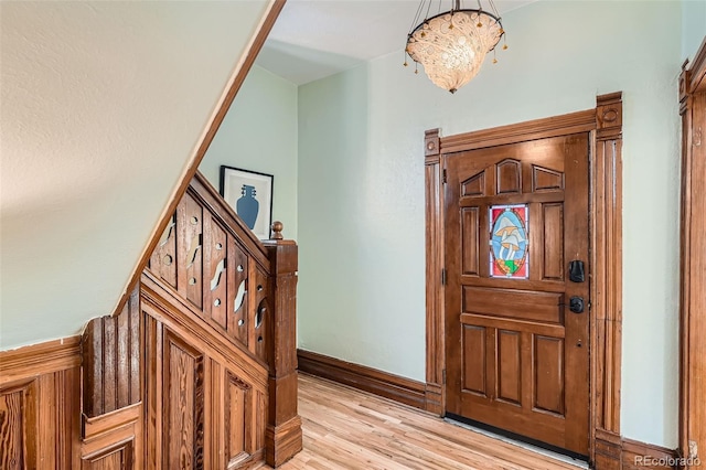 209 S Lincoln St, Denver, CO 80209 - entrance foyer featuring light wood-style flooring, a chandelier, baseboards, and stairway