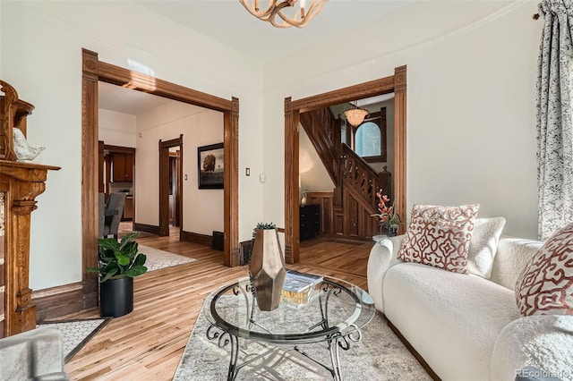 209 S Lincoln St, Denver, CO 80209 - living area with a chandelier, wood finished floors, and baseboards