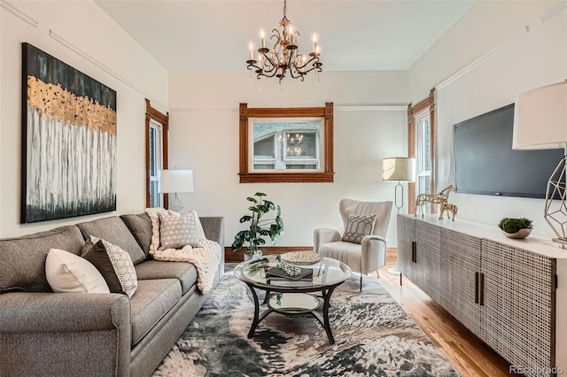 209 S Lincoln St, Denver, CO 80209 - living area featuring light wood-type flooring, a chandelier, and baseboards