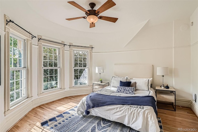 209 S Lincoln St, Denver, CO 80209 - bedroom with multiple windows, wood finished floors, and a ceiling fan