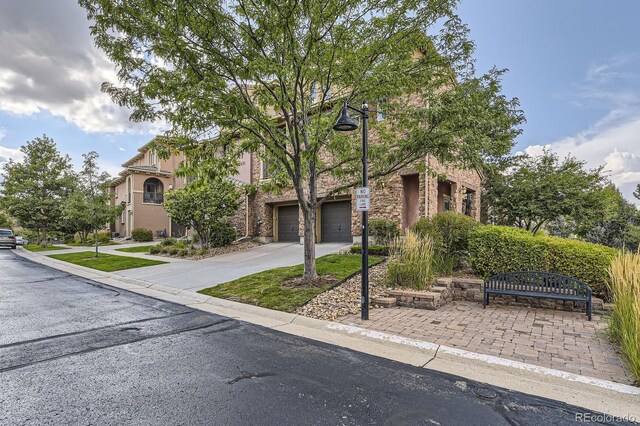 3491 Cascina Pl Unit D, Highlands Ranch, CO 80126 - obstructed view of property with concrete driveway and a garage