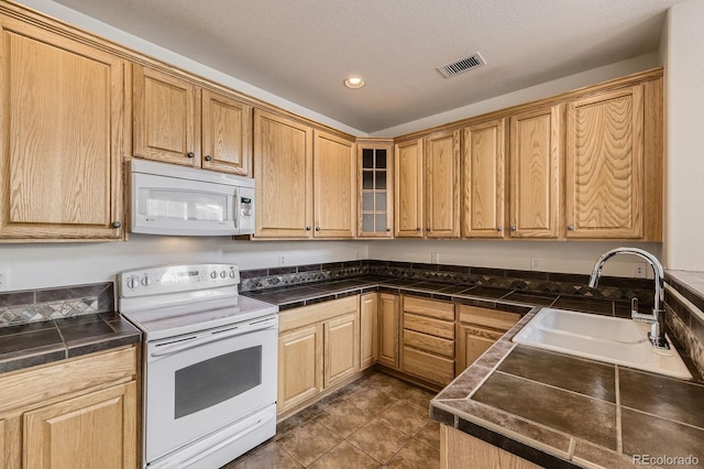 3491 Cascina Pl Unit D, Highlands Ranch, CO 80126 - kitchen featuring white appliances, recessed lighting, glass insert cabinets, tile countertops, and dark tile patterned flooring