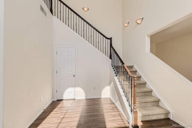 3491 Cascina Pl Unit D, Highlands Ranch, CO 80126 - stairs with a towering ceiling and wood finished floors