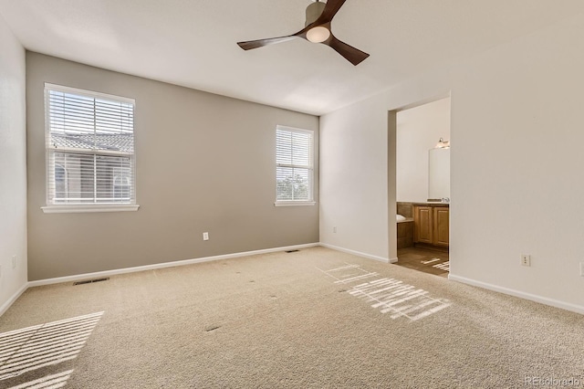 3491 Cascina Pl Unit D, Highlands Ranch, CO 80126 - unfurnished bedroom with light colored carpet, connected bathroom, and ceiling fan