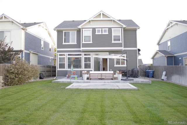 rear view of house featuring an outdoor living space, a lawn, and a patio area