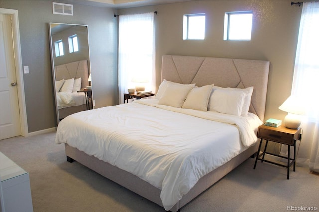 bedroom featuring carpet flooring and multiple windows