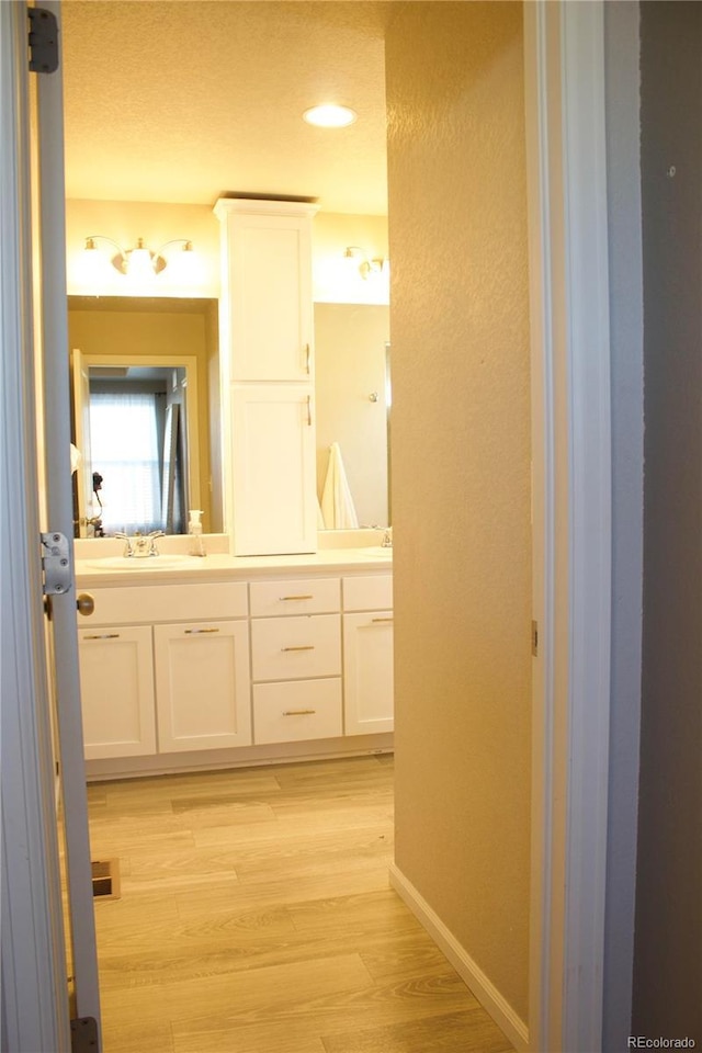 bathroom featuring hardwood / wood-style flooring and vanity