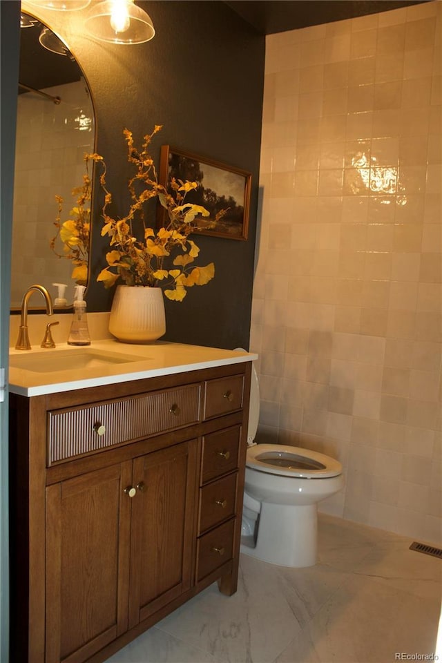 bathroom featuring vanity and toilet