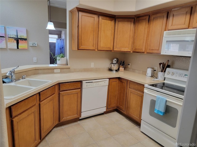 kitchen with sink, decorative light fixtures, and white appliances