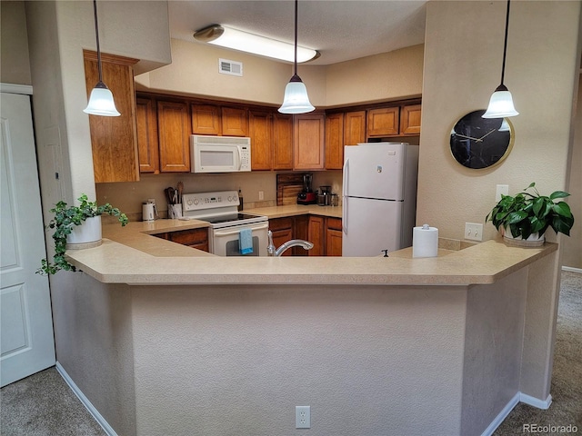 kitchen with carpet flooring, pendant lighting, and white appliances