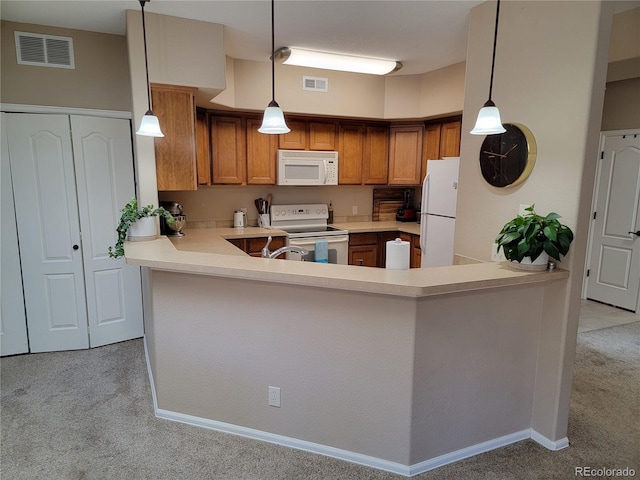 kitchen with kitchen peninsula, pendant lighting, light colored carpet, and white appliances