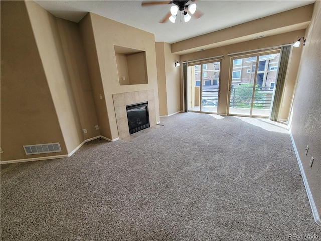 unfurnished living room featuring carpet flooring, ceiling fan, and a fireplace