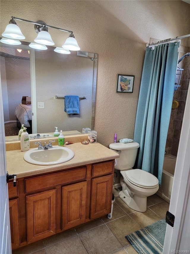 full bathroom featuring tile patterned flooring, shower / bath combo, vanity, and toilet