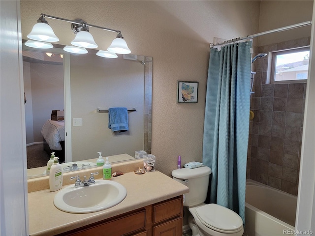 full bathroom featuring shower / tub combo with curtain, vanity, and toilet