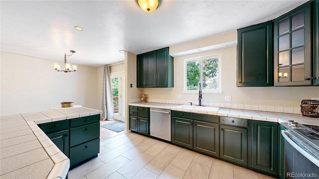 10718 Ash Ct, Thornton, CO 80233 - kitchen with appliances with stainless steel finishes, green cabinetry, a chandelier, glass insert cabinets, and pendant lighting