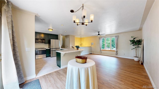 10718 Ash Ct, Thornton, CO 80233 - kitchen with stainless steel appliances, tile countertops, a chandelier, light wood-type flooring, and a ceiling fan