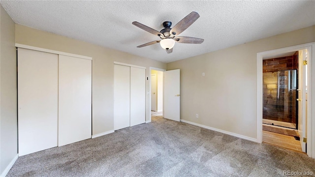 10718 Ash Ct, Thornton, CO 80233 - unfurnished bedroom with carpet floors, two closets, a textured ceiling, ensuite bathroom, and ceiling fan