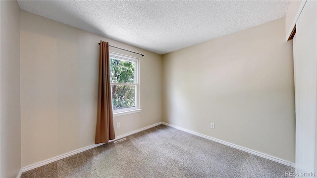 10718 Ash Ct, Thornton, CO 80233 - carpeted empty room featuring a textured ceiling and baseboards