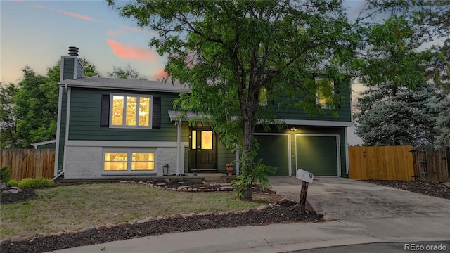 10718 Ash Ct, Thornton, CO 80233 - view of front of property with a chimney, concrete driveway, a garage, and brick siding