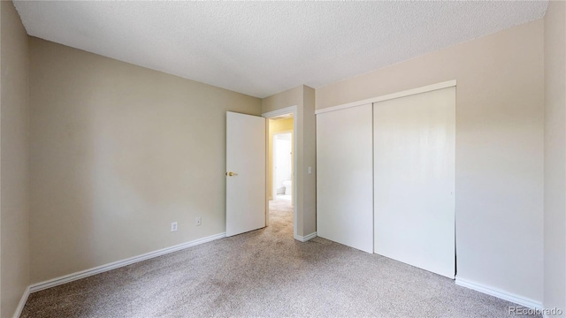 10718 Ash Ct, Thornton, CO 80233 - unfurnished bedroom with carpet, a closet, and a textured ceiling