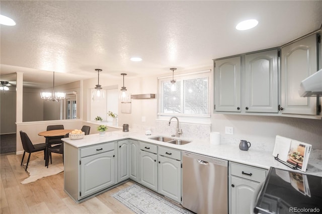 1409 S Moline St, Aurora, CO 80012 - kitchen featuring dishwasher, a peninsula, light countertops, light wood-style flooring, and hanging light fixtures