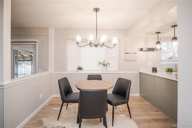 1409 S Moline St, Aurora, CO 80012 - dining room with light wood-type flooring and a chandelier