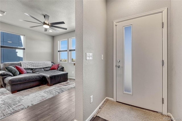 entryway featuring hardwood / wood-style floors, a textured ceiling, and ceiling fan