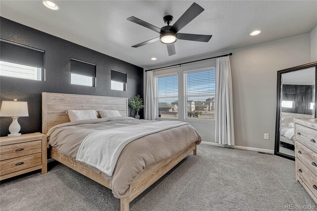 bedroom with carpet flooring, a textured ceiling, and ceiling fan