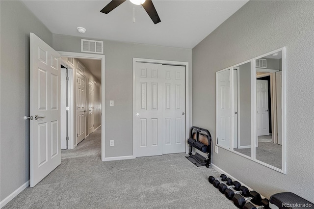 unfurnished bedroom with light colored carpet and ceiling fan