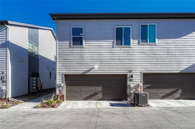 view of home's exterior featuring a garage and cooling unit