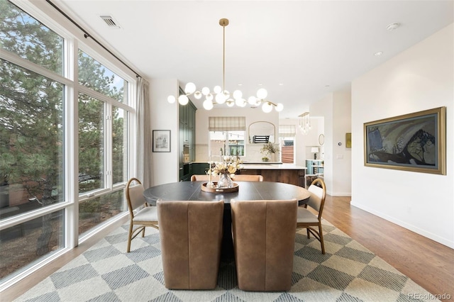 3220 Zuni St, Denver, CO 80211 - dining space featuring healthy amount of natural light, a chandelier, and light wood-style floors
